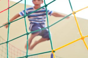 young boy jumping on a trampoline