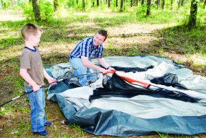 Dad teaching son camping safety