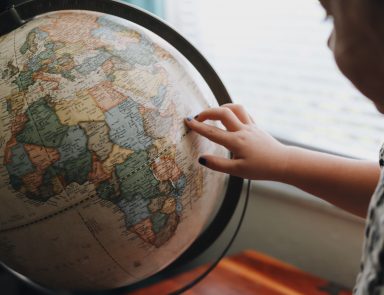 Child touching a globe
