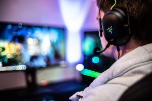 Boy wearing headphones playing on computer