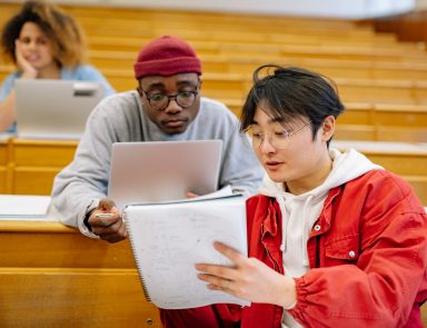 Two boys studying in a college lecture hall.