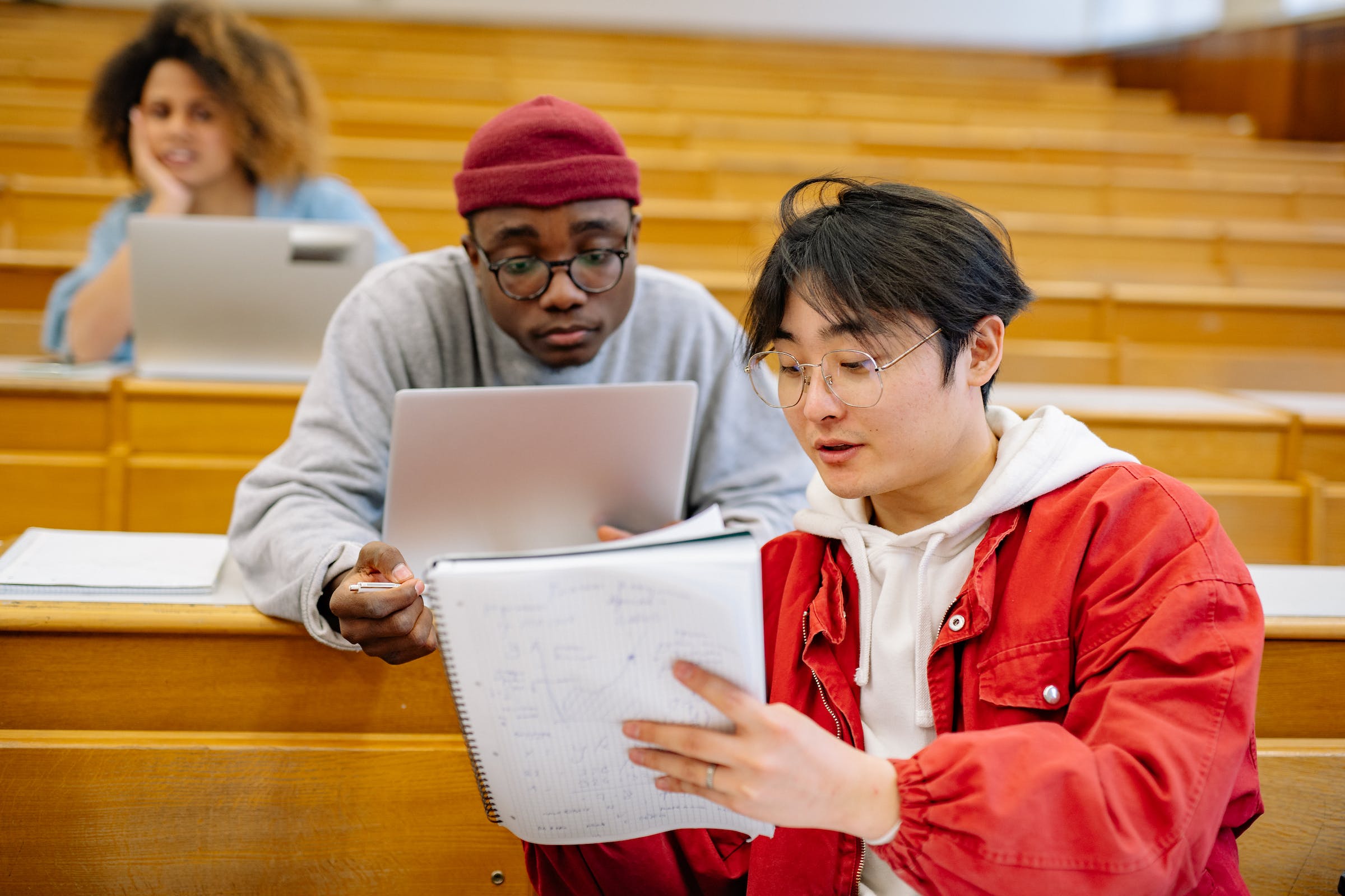 Two boys studying in a college lecture hall.