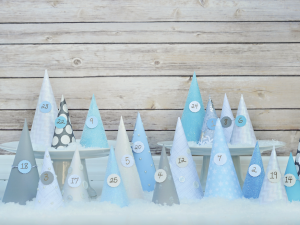 Blue paper cones with numbers on them on wood background