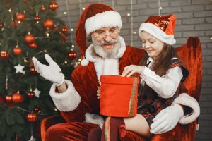 Santa giving girl a present