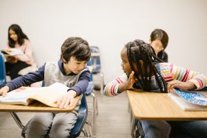 Two children talking in class