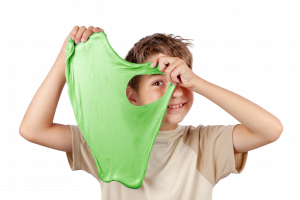 Young boy holding green slime