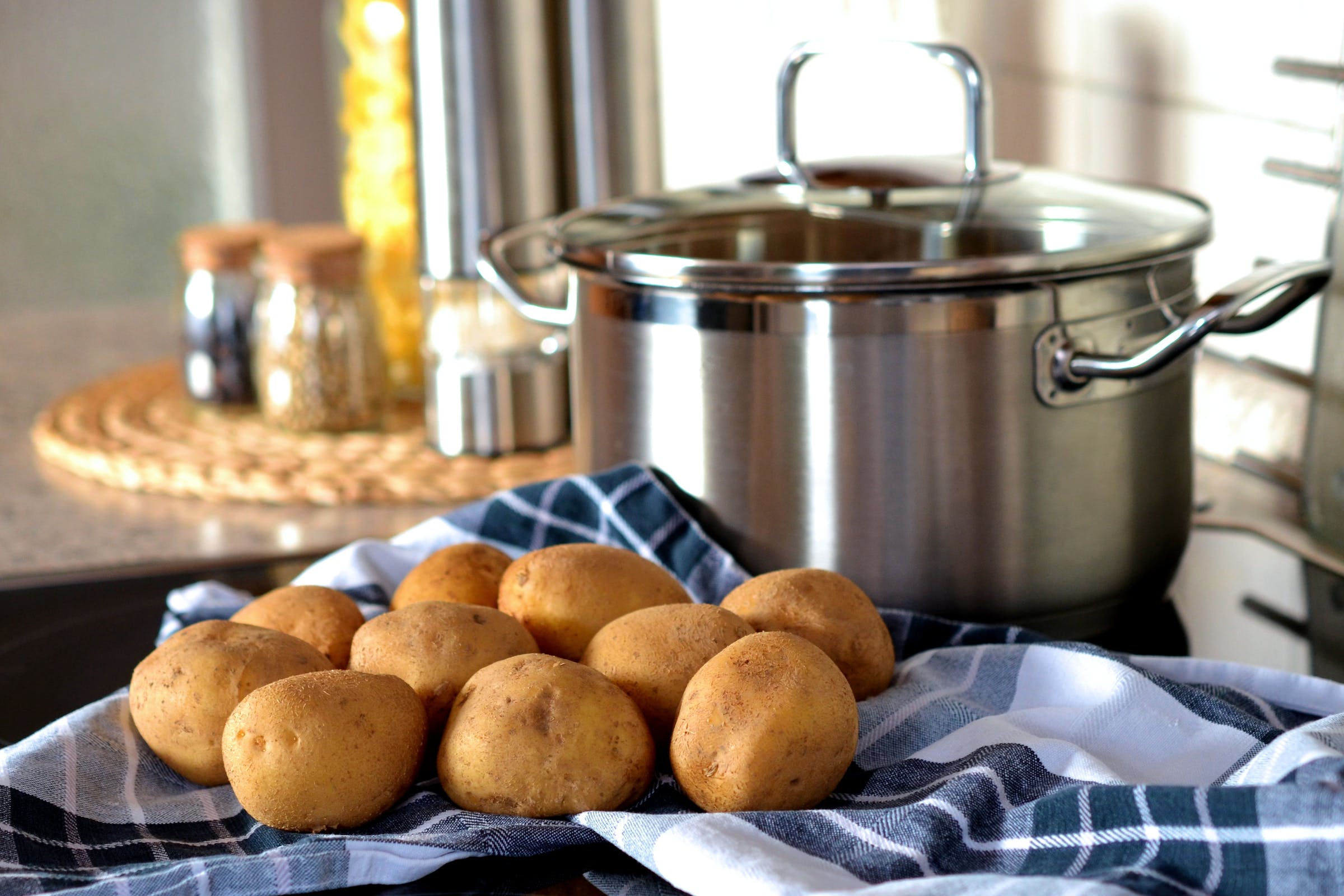Image of pot with raw potatoes next to it on the counter