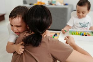 Mom holding crying son