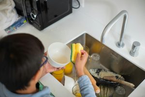 Child washing dishes