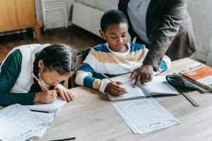 Two kids getting help with their homework