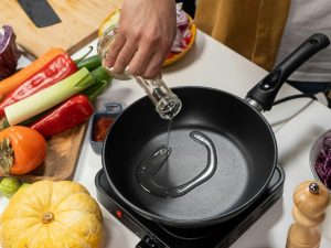 Person pouring cooking oil