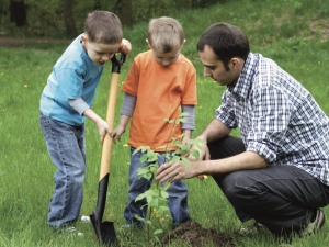 Dad working outside with two sons