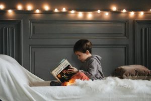 Child reading in bed