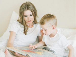 Child reading with mother