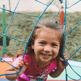 Girl smiling on playground at summer camp