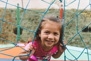 Girl smiling on playground at summer camp