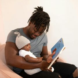 Father reading to his baby