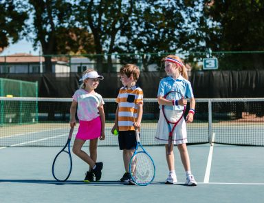 Young kids playing tennis