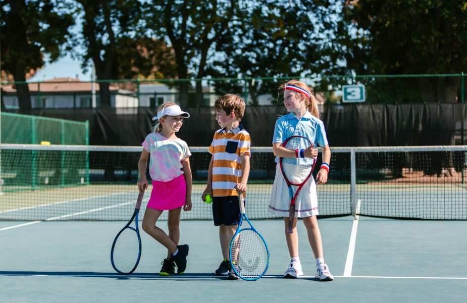 Young kids playing tennis