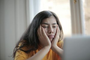 Girl sitting looking bored