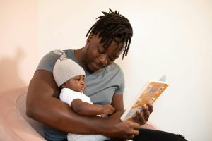 Dad reading to baby