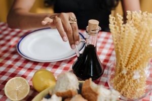 Woman grabbing balsamic vinegar