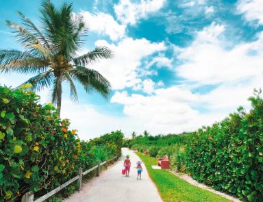Kids walking along beach in Florida