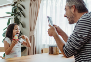 Dad sharenting and taking photo of child