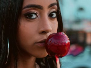 Woman holding a candied apple
