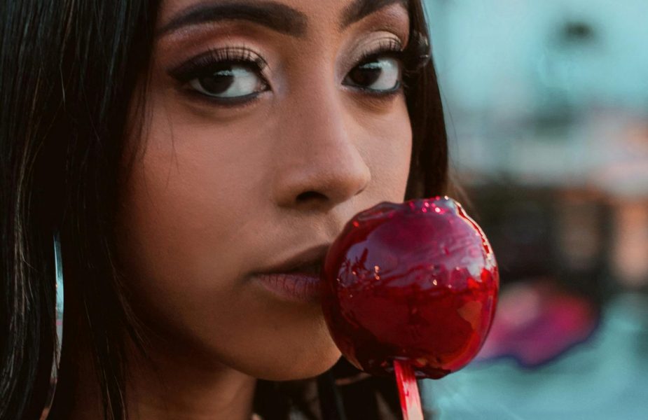 Woman holding a candied apple